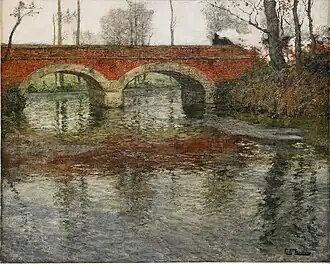 French river landscape with a stone bridge