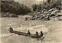 Thirty-foot canoe in a rapid above Pongo de Mainique. (1916)