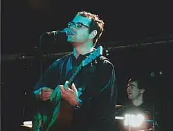 Mason (foreground) and Jones performing at Guilfest, 2004