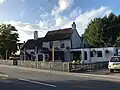 The Chequers pub, listed at grade II[5]