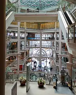 The Gallery at Harborplace's interior, as viewed from the third floor, on April 3, 2015, shows Starbucks on the second floor. Fifth floor seen on the top, with the windows covered in curtains.