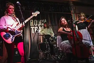 (L–R): Kate Mager, Ella Oona Russell, Nina Winder-Lind, and Violet Farrer performing as The New Eves in 2025