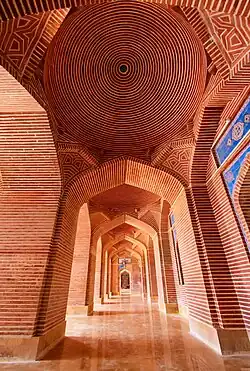 Arcades around the central courtyard feature bricks laid in geometric patterns