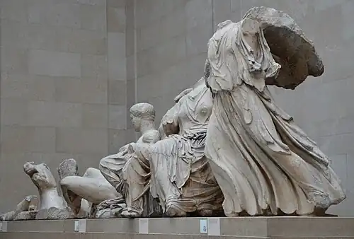 Several three-dimensional ancient Greek sculptures arranged in a row