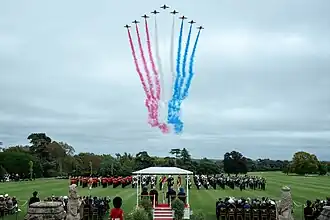 The President and the First Lady watch a military parade with the King and Queen at Windsor Castle.