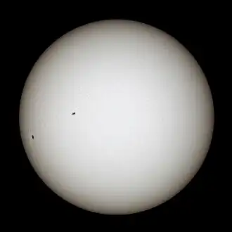 White glowing ball with black sunspots