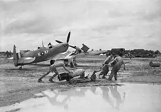 A Supermarine Spitfire Mark VIII of No 607 Squadron is prepared by an RAF crew during monsoon conditions at Mingaladon for a sortie against the Japanese break-out attempt at Sittang