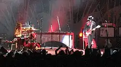 The White Stripes performing in 2005, with Meg White playing drums on the left and Jack White playing guitar on the right