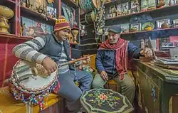Tunisia, 2017. Musician playing large-bodied gombri.