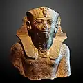 Granite bust of Thutmose IV. Weathered to just the torso. Currently held at the Musée du Louvre.
