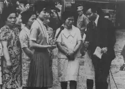 Women being interviewed by reporters