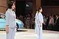 Nissan promotional models wear pantsuits at the 2009 Tokyo Motor Show, Japan