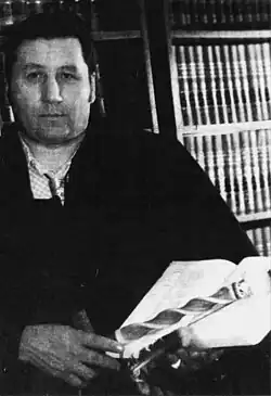 Tom Maulson holding a book