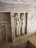 Sculpted figures (right) and false door (left) on the west wall