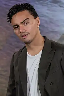 A head shot of Tonatiuh as he looks away from the camera