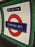Station roundel with a direction of the way out