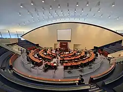 circular room with rows of seats around central tables