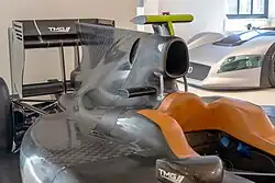 A black engine cover above the sidepods of a Formula One car.