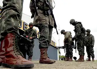 Brazilian soldiers with cobwebbed boot laces using green paracord