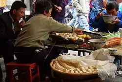 Tofu and potatoes grilled at a street stall in Yuanyang, Yunnan province, China
