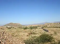 The Twin Buttes Cemetery and surrounding area. The Twin Buttes formation is at the left.
