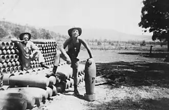 Two Air Force workers stacking explosives during World War II