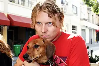 Segall posing with his dog, Fanny, in 2016