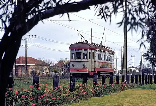 Photo of a silver-liveried interurban-style Glenelg tram on the sole-use section of the Glenelg tram line