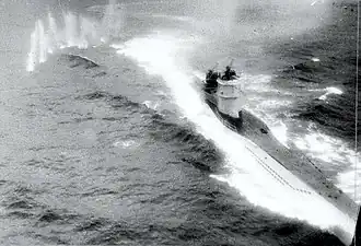 Black and white photograph of a surfaced submarine