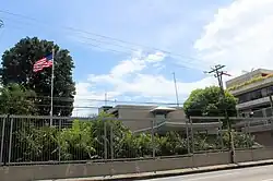The Embassy of the United States, Port of Spain, complex, viewed from behind a fence.
