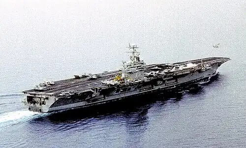 USS&nbsp;Theodore Roosevelt launches an F-14 Tomcat while F/A-18 Hornets wait their turn during the Kosovo War