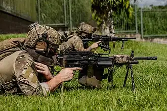 U.S. Navy SEAL aiming a Mk 48 Mod 2
