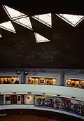 Inside of a three-story building featuring a geometric eagle-shaped skylight