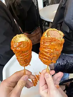 Corn dogs with vegan cheese (left) and vegan sausage (right) at a German Christmas Market in Leipzig