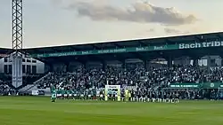 The interior of Energi Viborg Arena, showing two teams lining up in front of a crowd