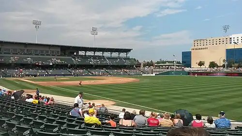 A green baseball field surrounded by a seating bowl