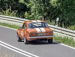 Orange car viewed from the rear.