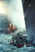 6 WTC on fire during the September 11 attacks, visible behind 7 WTC and its footbridge.