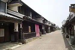 Wooden houses with white walls, roof tiles and protruding walls.