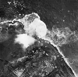 Aerial photograph of bombs exploding on dike on 3 October 1944
