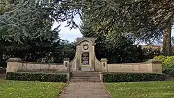 Curved natural stone plinth with a central plaque
