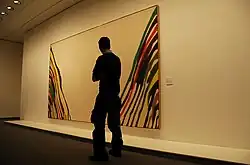 A museum visitor viewing Morris Louis's Beta Zeta at the Neue Nationalgalerie, Berlin[9]
