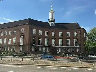 Brick building with curved concave frontage and clock