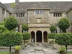 Two-storey house with columns in front of the door.