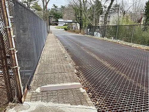 The original bridge's sidewalk, with its corroded rebar visible