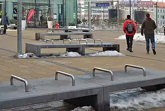 Benches with metal pipes to prevent lying down at a train station in Vienna