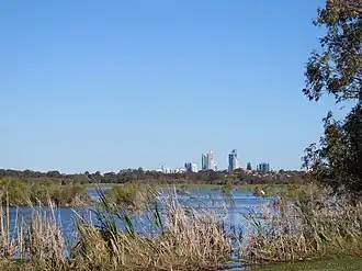 The western shore of Herdsman Lake with the skyline of Perth in the background