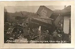 A derailed freight train with broken and mangled boxcars