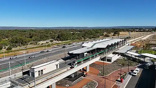 An elevated train station on a concrete viaduct
