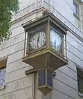 Whittier Village Clock, mounted on the building's corner.